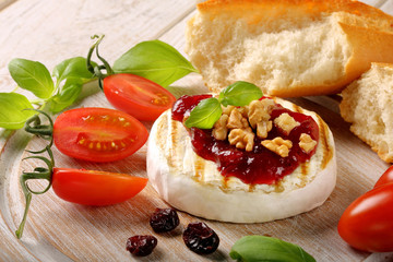 Grilled brie cheese with cranberry jam and walnuts