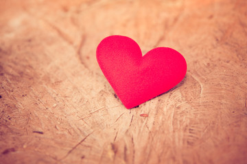 Fototapeta na wymiar Valentine day background. Vintage red heart on wood