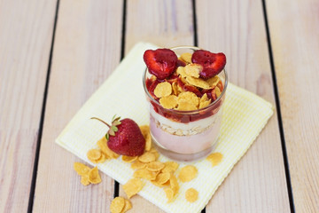 yogurt with strawberries and corn flakes