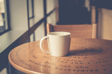 A mug of hot coffee on table. vintage filter