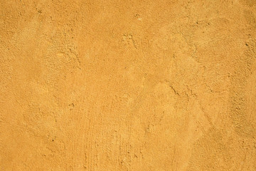 Texture of grungy old yellow concrete background