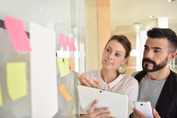 Young business people using tablet in office