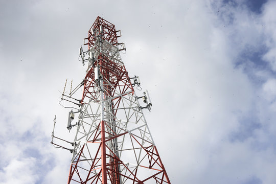 Telecommunication tower with a blue sky and clouds, selective focus