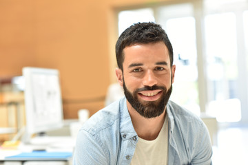 Portrait of trendy businessman in meeting room