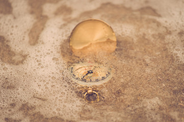 Vintage compass on sand beach