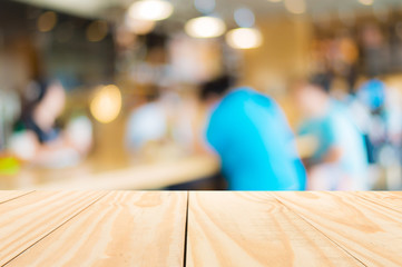 Wood table on blur people in cafe. for display products