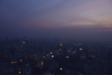 Blurred aerial view of cityscape on warm light sundown