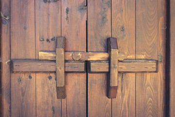 closed wooden door with locking bar , vintage