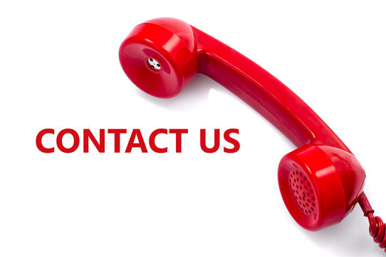 Old and dust red retro phone on white, contact us concept.