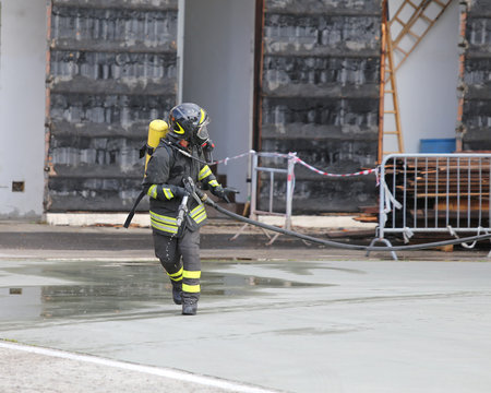 firefighters with breathing apparatus and oxygen cylinder runs