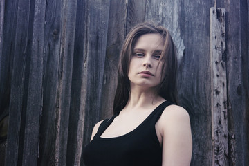 Fototapeta premium Portrait of a young girl on a wooden background