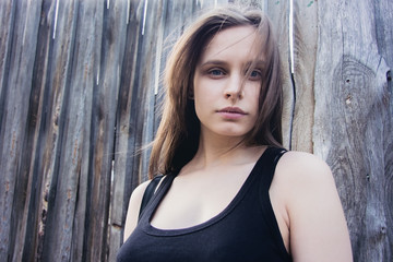 Fototapeta premium Portrait of a young girl on a wooden background