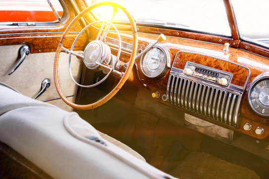 Fototapeta Interior of a classic vintage car with sun glare