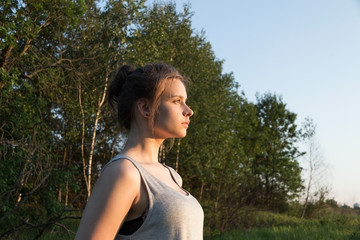 Naklejka premium beautiful young girl on the background of nature
