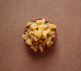 Raisins wooden basket on a wooden background
