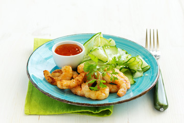 Salad with cucumber Asian style with fried shrimp.