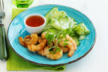 Salad with cucumber Asian style with fried shrimp.