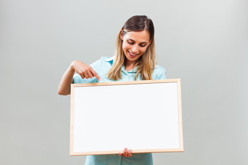 Beautiful nurse is pointing at whiteboard.
