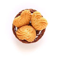 Cookies in heart shape with wooden basket on White background