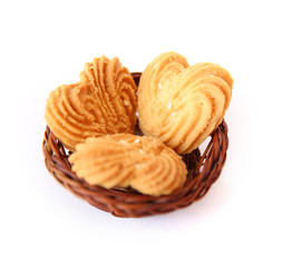 Cookies in heart shape with wooden basket on White background