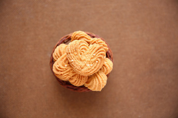 Cookies in heart shape with wooden basket on White background