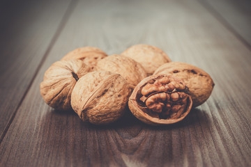 three walnuts on the brown wooden table background