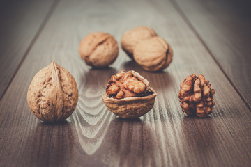 three walnuts on the brown wooden table background