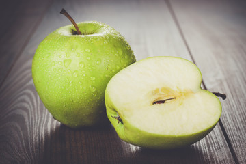 fresh green apples on the wooden table