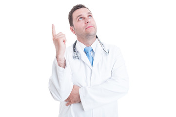 Young doctor or medic looking up and having great idea