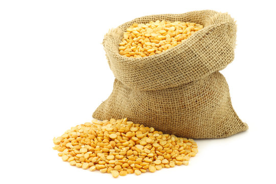 Yellow Split Peas In A Burlap Bag On A White Background