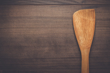 wooden spatula on the brown table background