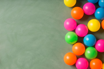 Fototapeta na wymiar Green chalkboard and colorful balls