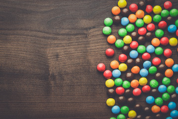 colorful sweets on the brown wooden table background