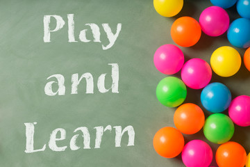 Green chalkboard and colorful balls. Play and learn