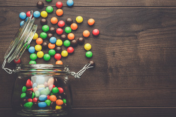 topple over glass jar full of colorful sweets