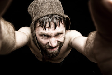 Dark portrait of scary evil sinister bearded man with smirk, makes various hand's signs and...
