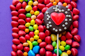 Wall murals Sweets Arranged colorful sweets with chocolate heart lollipop