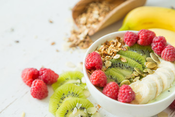 Smoothie in a bowl with fruits and seeds