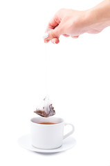 Hand with a tea bag on a