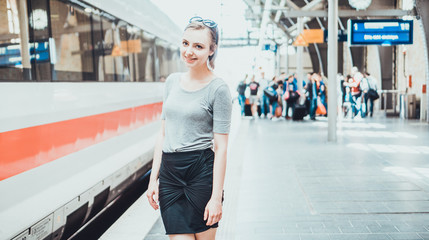 Happy young woman standing on a platform