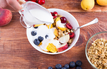 The person cooks fruit salad.