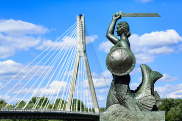 Fototapeta na wymiar The mermaid statue on the Vistula river bank in Warsaw, Poland. Photo with shallow depth of field.