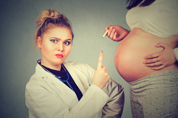 Closeup angry upset doctor pointing at pregnant woman with cigarette in hand