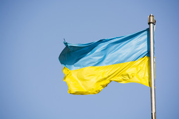 Developing Ukrainian flag on the background of the sky