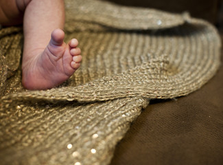 baby leg with brown blanket