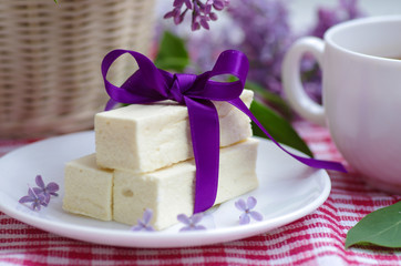 Russian sweet white marshmallow on the table and lilac