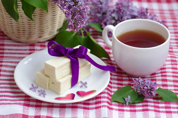 Russian sweet white marshmallow on the table and lilac