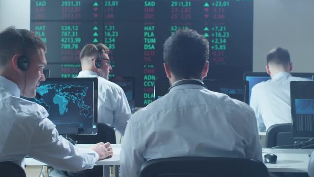 Group of Stockbrockers Actively Working at Stock Exchange. Shot on RED Cinema Camera in 4K (UHD).