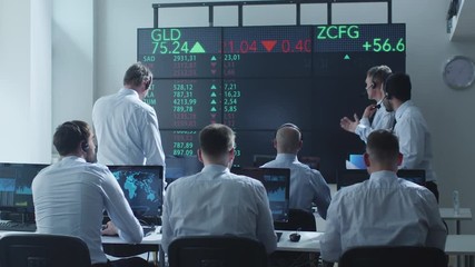 Group of Stockbrockers Actively Working at Stock Exchange. Shot on RED Cinema Camera in 4K (UHD).