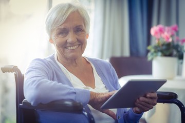 Happy senior woman using digital tablet